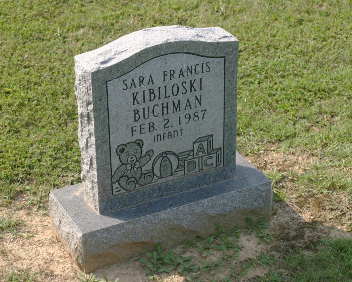 This is an example of a child's monument, engraved with teddy bears and toys. 